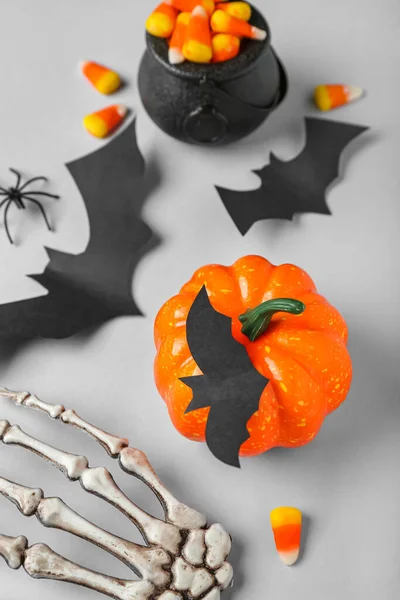 Paper Bats Halloween Pumpkin Candy Corns Skeleton Hand Grey Background — Stock Photo, Image
