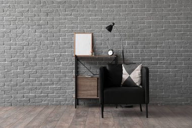 Siyah koltuğu ve raf ünitesi olan modern oturma odası.