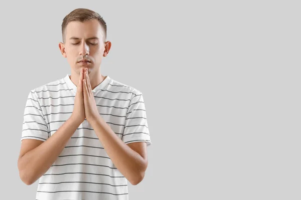 Young Man Meditating Light Background — Stock Photo, Image