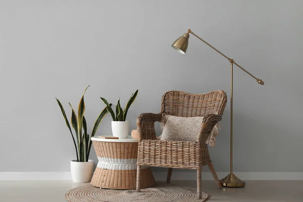 Wicker Armchair Table Houseplants Lamp Grey Wall — Stock Photo, Image
