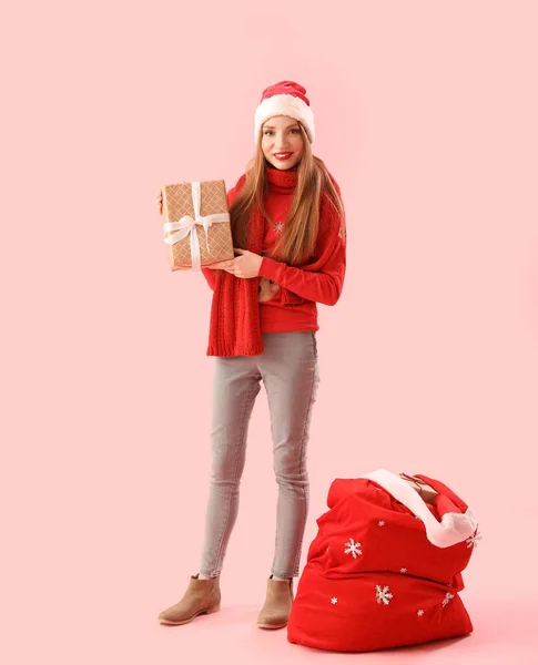 Mooie Jonge Vrouw Santa Hoed Met Kerstcadeau Tas Roze Achtergrond — Stockfoto