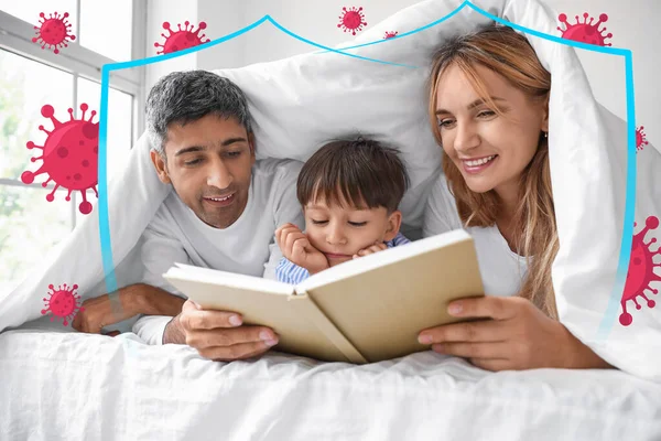 Parents reading book to their little son in bed. Concept of strong immunity