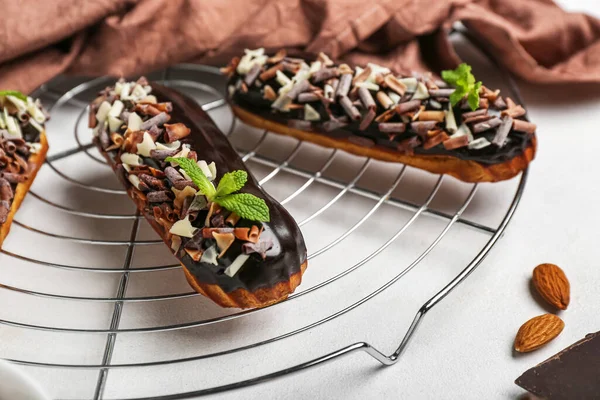 Grid Tasty Chocolate Eclairs Light Background Closeup — Stock Photo, Image