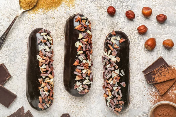 Tasty Chocolate Eclairs Hazelnuts Light Background Closeup — Stock Photo, Image