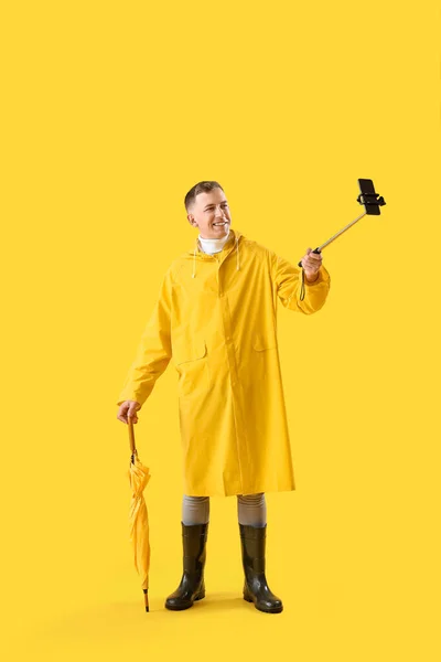 Young Man Umbrella Mobile Phone Taking Selfie Yellow Background — Stock Photo, Image