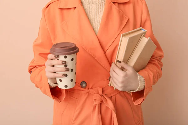 Mujer Con Taza Sabroso Café Libros Cerca Pared Color Beige —  Fotos de Stock