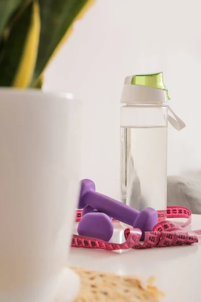 Dumbbells Measuring Tape Bottle Water Table Light Wall — Stock Photo, Image