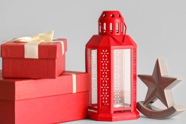 Beyaz arka planda yıldız ve fenerli Noel hediyeleri