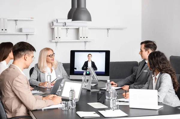 Business people having online meeting in office