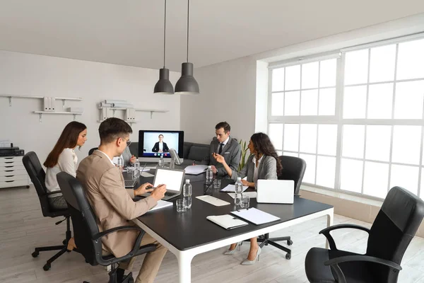 Business people having online meeting in office