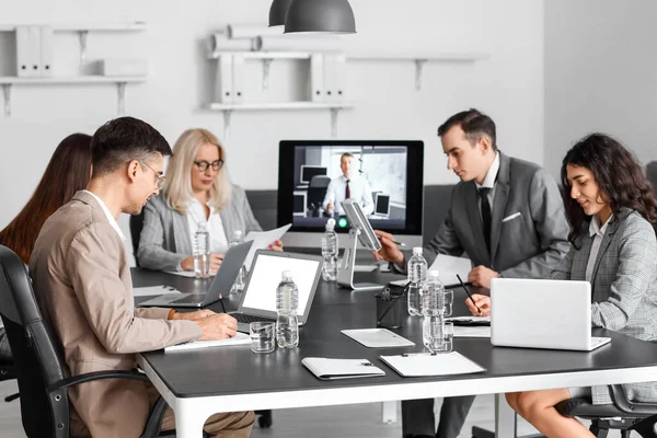 Business people having online meeting in office