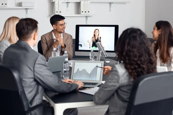 Business people having online meeting in office