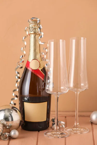 Fles Champagne Met Glazen Kerstballen Beige Houten Ondergrond — Stockfoto