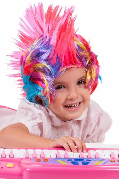 Little girl with colorful wigs — Stock Photo, Image