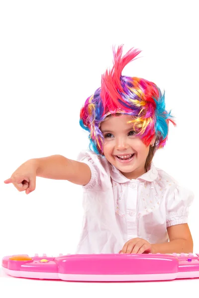 Little girl with colorful wigs — Stock Photo, Image