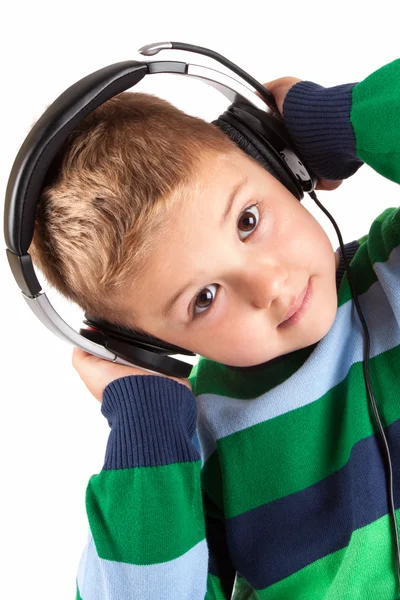 Lächelnder kleiner Junge hört Musik im Kopfhörer — Stockfoto