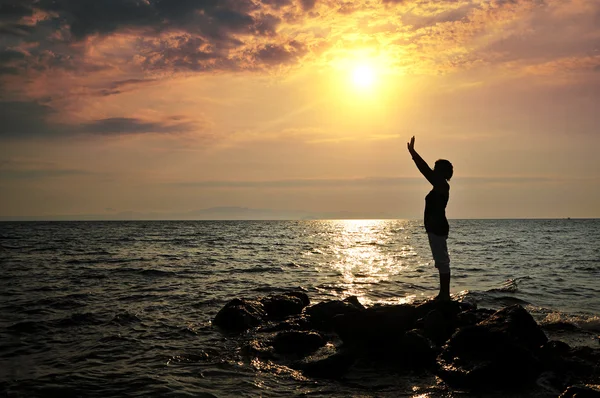 Young woman and boy standing on rock in sea and looking to somewhere — Stock Photo, Image