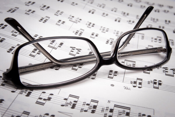 Reading glasses over the music sheets