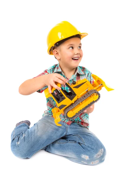 Menino brinca com trator de brinquedo — Fotografia de Stock