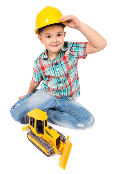 Little boy plays with toy tractor — Stock Photo, Image
