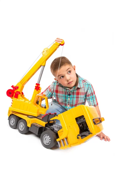 Little boy plays with toy truck — Stock Photo, Image