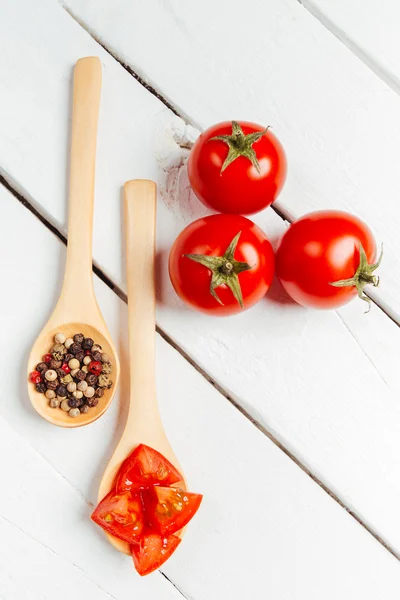 Tomato on wooden spoon — Stock Photo, Image