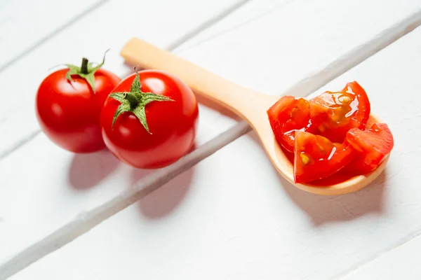 Tomato on wooden spoon — Stock Photo, Image