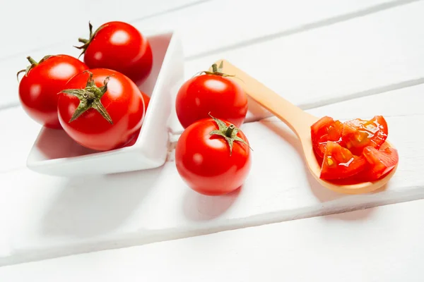 Tomato on wooden spoon — Stock Photo, Image