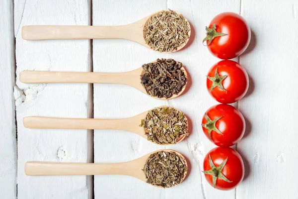 Tomato on wooden spoon — Stock Photo, Image