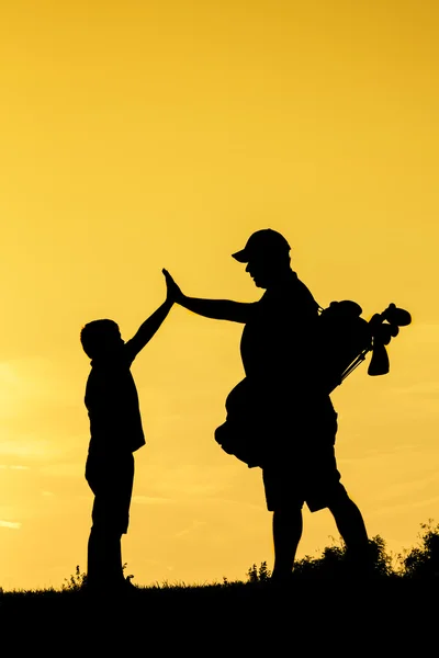 Golfer at sunset — Stock Photo, Image