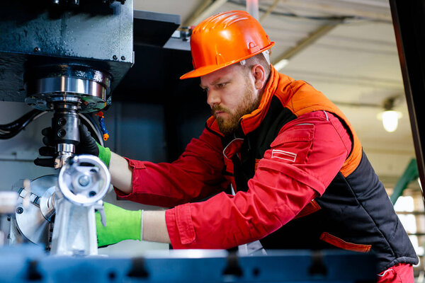 Mechanical technician operative of cnc milling cutting machine center at tool workshop