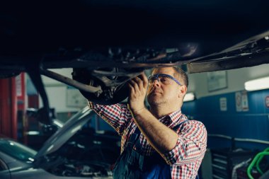 Bir araba servisinde çalışan yakışıklı bir tamircinin portresi..