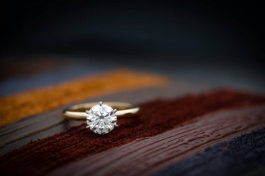 Gold Engagement Diamond Ring on Colored Leather