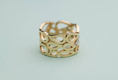 Gold Jewelry Ring on Bright Blue Background