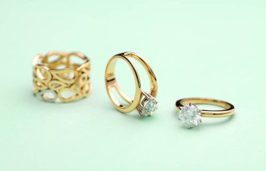 Gold Engagement Diamond Ring on Tiffany Color Background