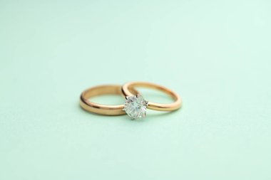 Gold Engagement Diamond Ring on Tiffany Color Background