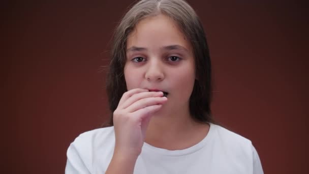 Caucásico Chica Comiendo Galleta Marrón Fondo — Vídeos de Stock