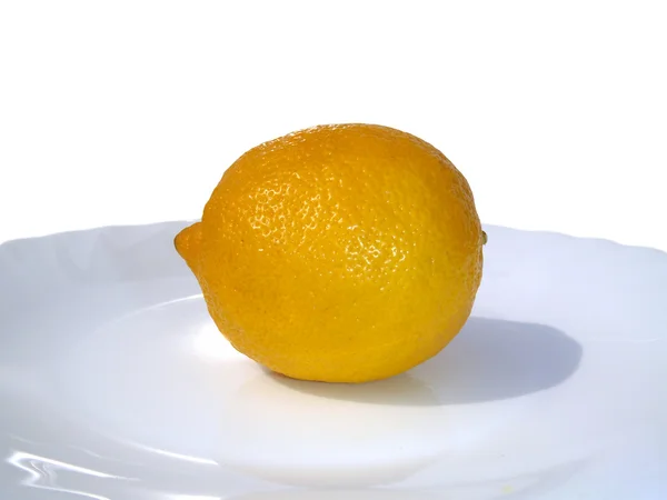 Ripe lemon on a plate. — Stock Photo, Image