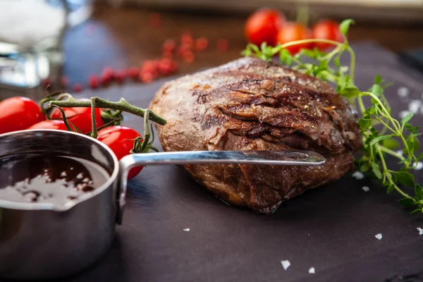 Lamb steak with cherry tomatoes and wine sauce. Delicious healthy traditional food closeup served for lunch in modern gourmet cuisine restaurant — Stock Photo, Image