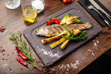 Gökkuşağı alabalığı ızgarada. Sebze, beyaz şarap sosu. Modern gurme yemek restoranında öğle yemeği olarak sunulan lezzetli, sağlıklı geleneksel yemekler..