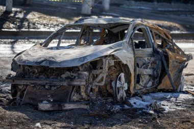 View of burnt car on one of the streets in Kharkiv after rocket bomb attack by Russian occupying military. Russian army aviation forces bombed civilian objects. War of Russia against Ukraine. 21.03.2022, Kharkiv, Ukraine