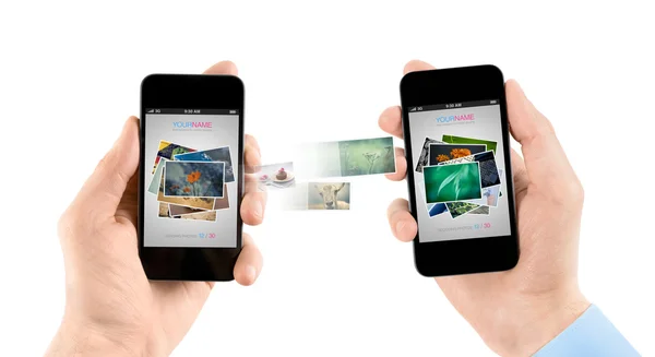 Mobile smart phones while transferring pictures — Stock Photo, Image