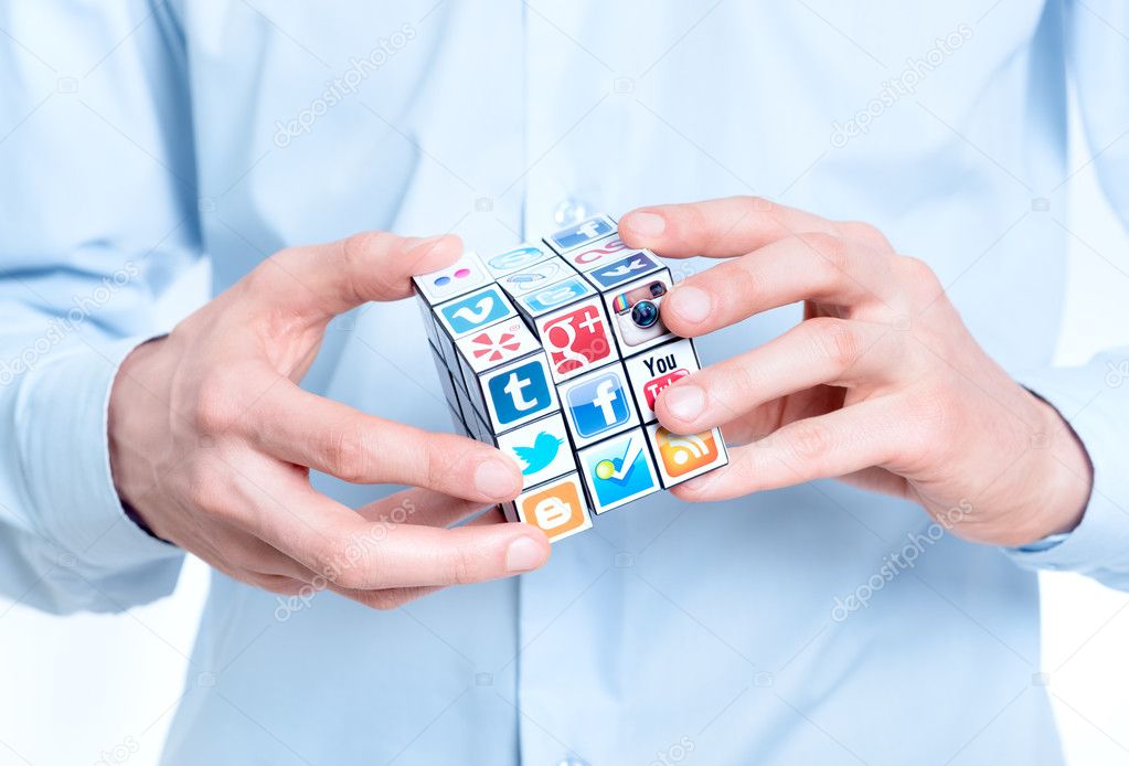 Kiev, Ukraine - February 2, 2013 - Businessman solving rubik's cube with logotypes of well-known social media brand's. Include Facebook, YouTube, Twitter, Google Plus, Instagram, Vimeo, Flickr, Myspace, Tumblr, Livejournal, Foursquare and other logos