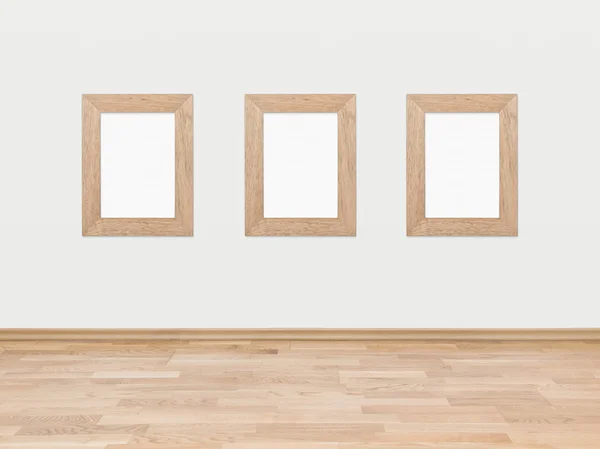 Empty wooden frames on a white wall — Stock Photo, Image