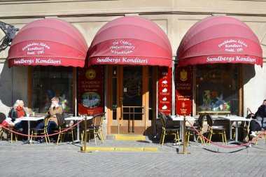 Cafe on the street of in Stockholm clipart