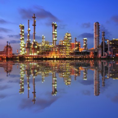 Reflection of petrochemical plant at night clipart