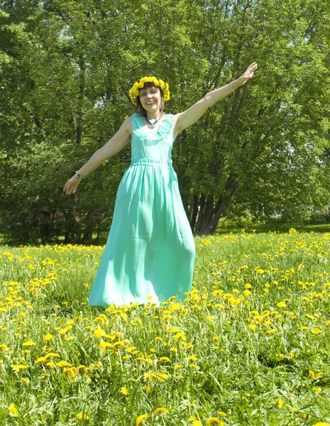 Woman on meadow with yellow dandelions — Stock Photo, Image