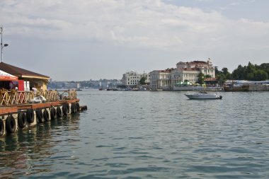 view on harbour and guay with buildings in city centre and cafe on water