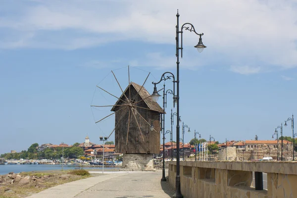 NESEBAR, BULGARIA - JUNE 07, 2019: windmill and road to old historical centre of the town Nesebar, UNESCO World heritage site, and view on the new Nesebar. — стокове фото