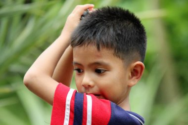 Asian Thai little boy play in the backyard